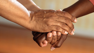 Three people holding hands